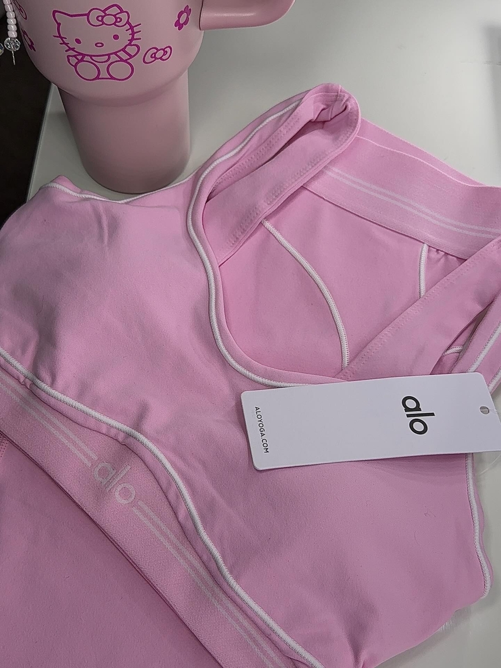 ALO Yoga Light Pink Racerback Sports Bra with White Piping